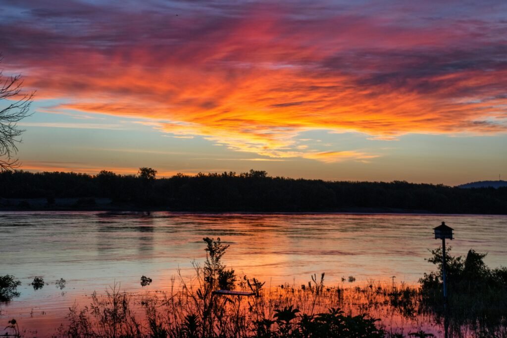 A vivid sunset paints the sky over Mississippi River at Reads Landing, creating stunning reflections on the water.