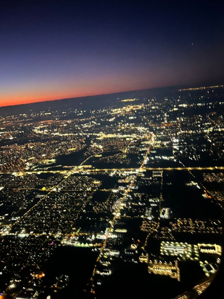 Picture of a city from overhead in an airplane at night. Sometimes when life gets busy, breathing can help.